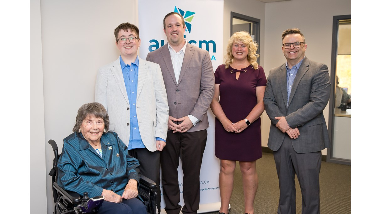Photo of Joan Craig, founder of Autism Nova Scotia; Ethan Rekunyk, who has autism and is an advocate; Brian Comer, Minister of Addictions and Mental Health; Cynthia Carroll, Executive Director, Autism Nova Scotia; and Brendan Maguire, Minister of Community Services