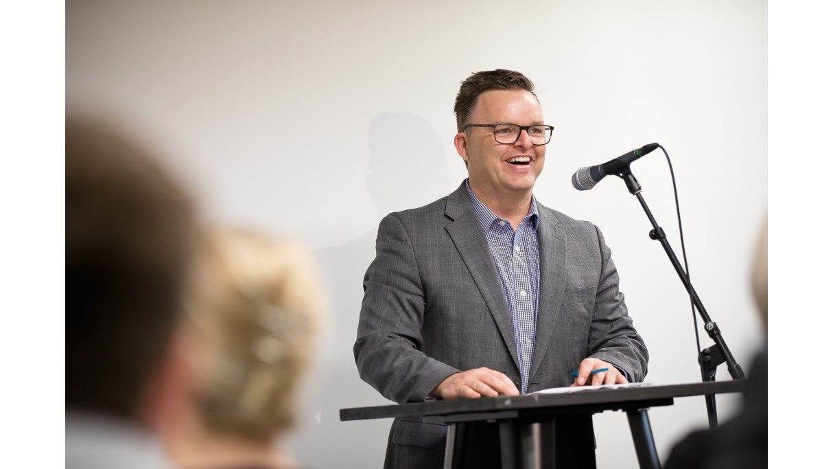 Photo of Community Services Minister Brendan Maguire at a podium