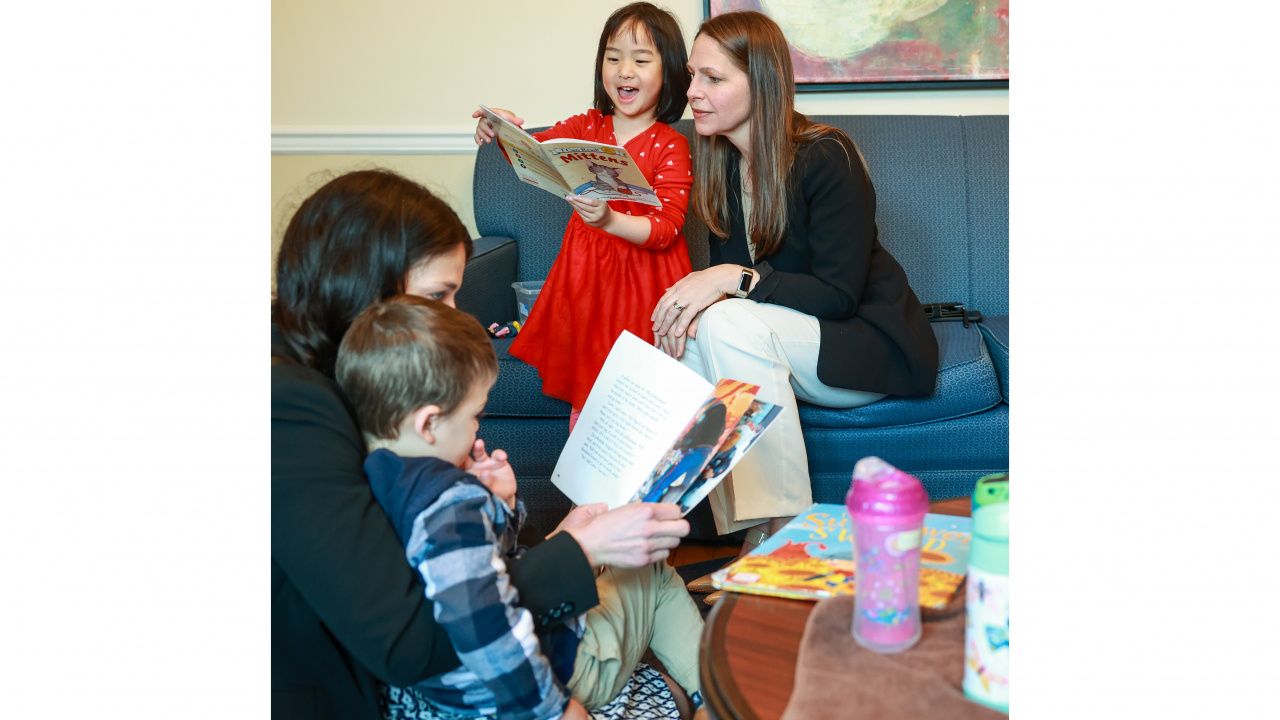 Photo of a child reading to Education and Early Childhood Development Minister Becky Druhan