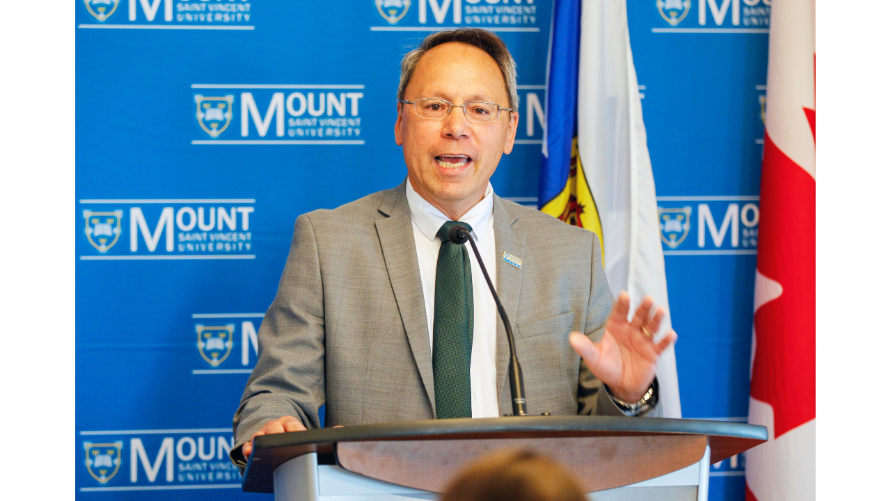 Photo of Advanced Education Minister Brian Wong at a podium