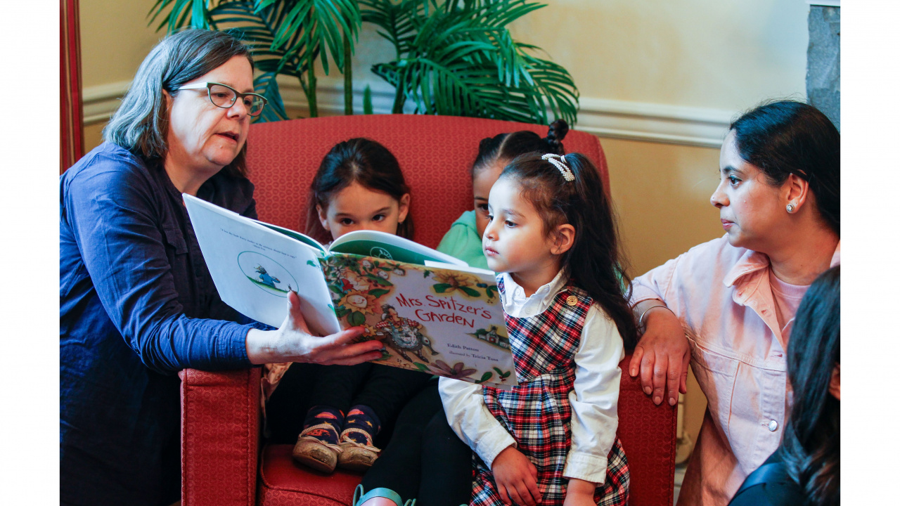 Photo of early childhood educator reading to children