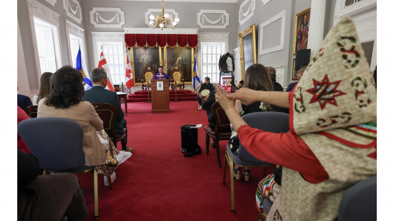 Photo of Mi'kmaw student at podium in the Red Chamber at Province House