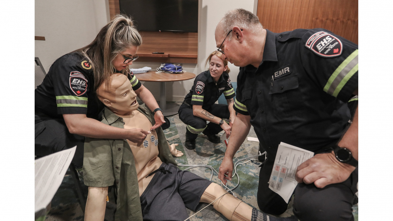 Emergency Health Services paramedics Samantha Lamplugh, left, and Kim Smith, centre, instruct Vince McNamara during orientation training in the Emergency Medical Responder Program this spring.