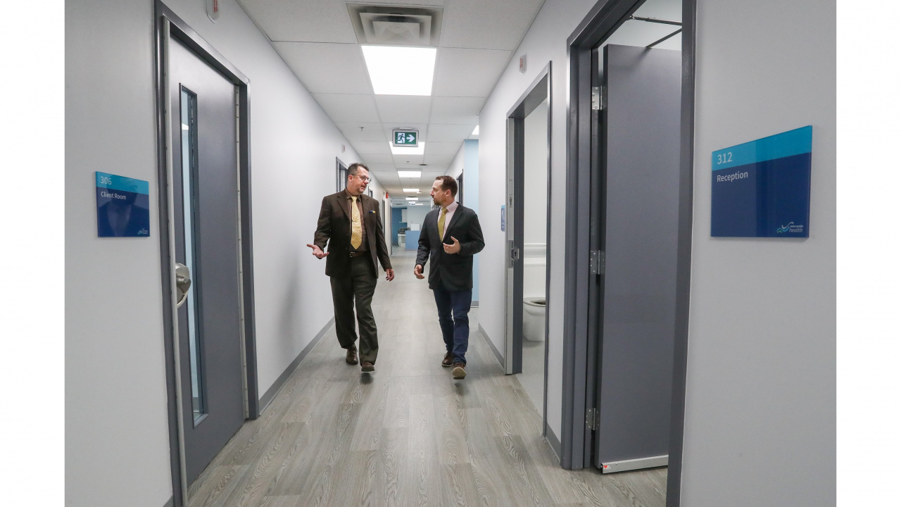 Dr. Sam Hickcox, left, and Dr. Dave Martell, right, walking down the corridor.