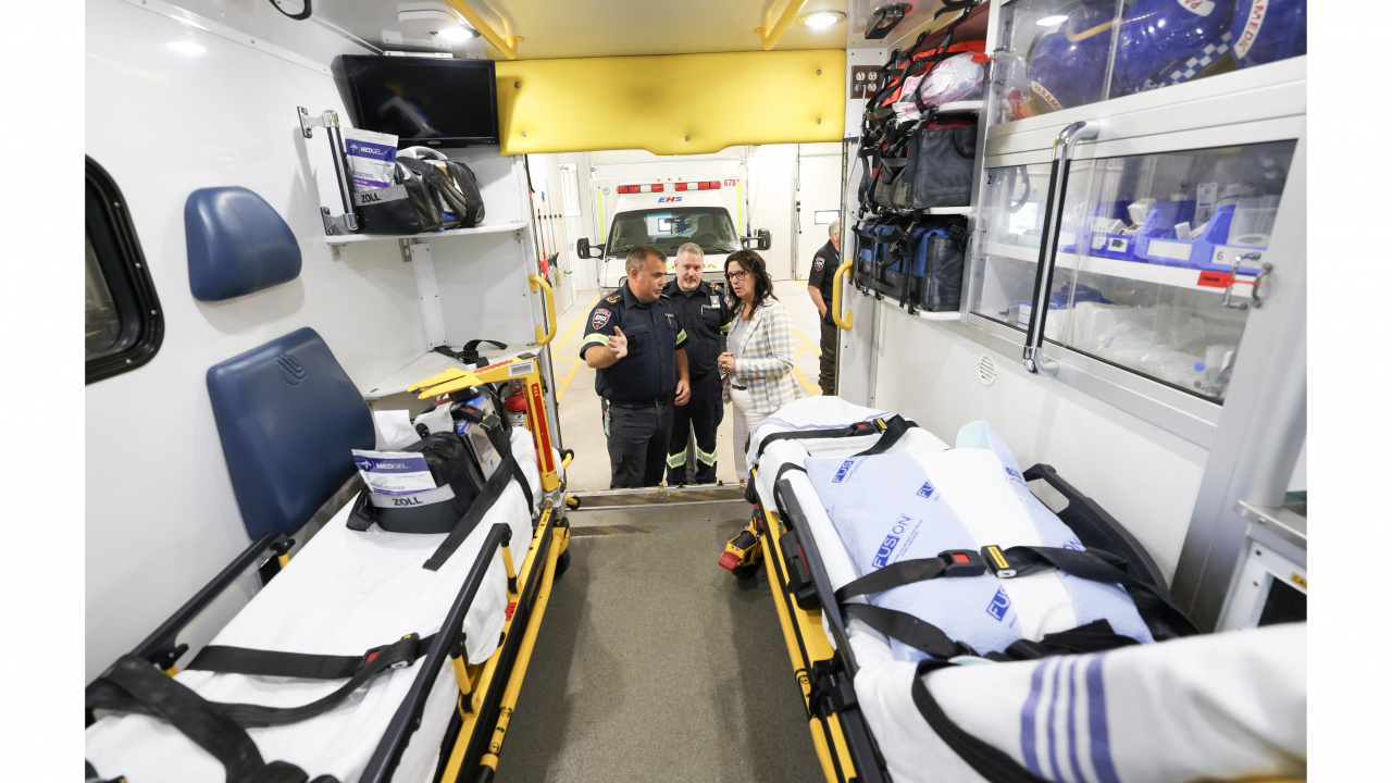 Health and Wellness Minister Michelle Thompson is shown the interior of  a patient transfer unit 