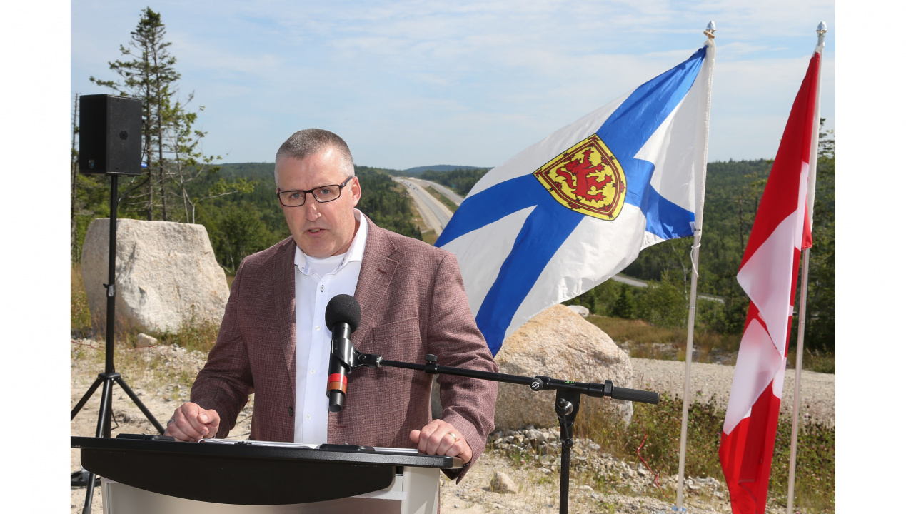 Photo of Mark Underhill of Dexter Construction at a podium