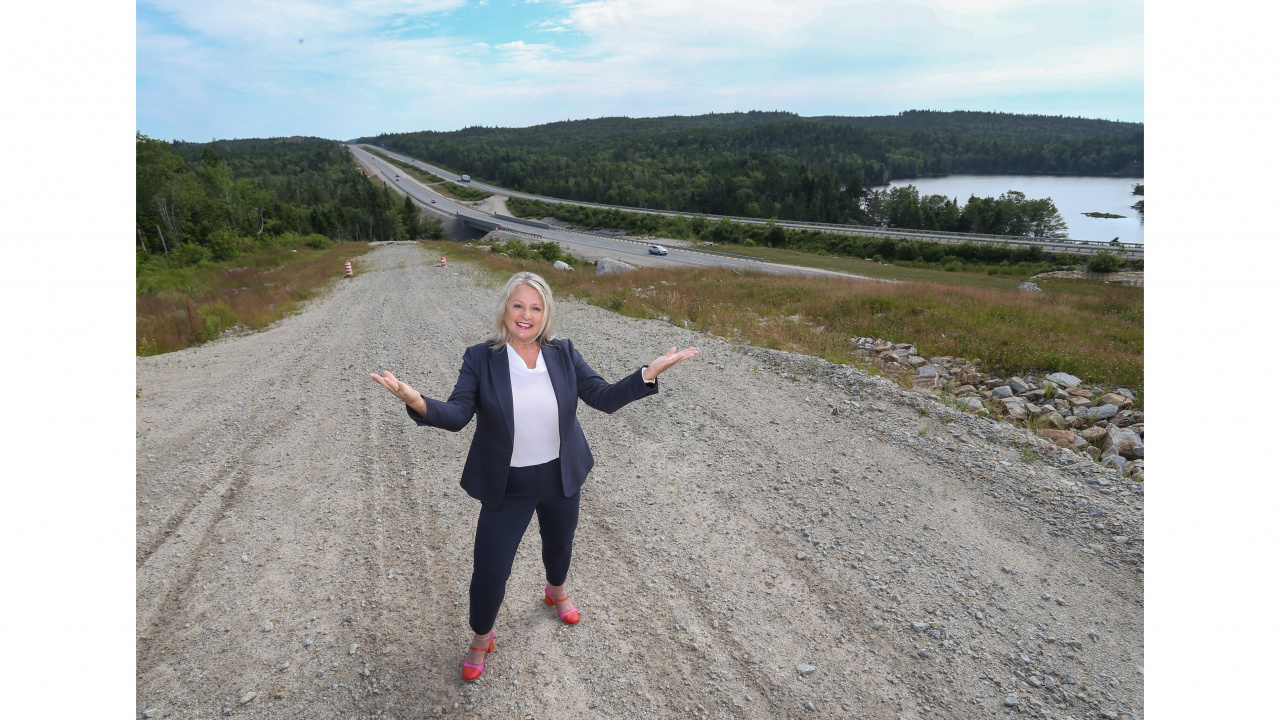 Photo of Public Works Minister Kim Masland outside with Highway 103 in the background