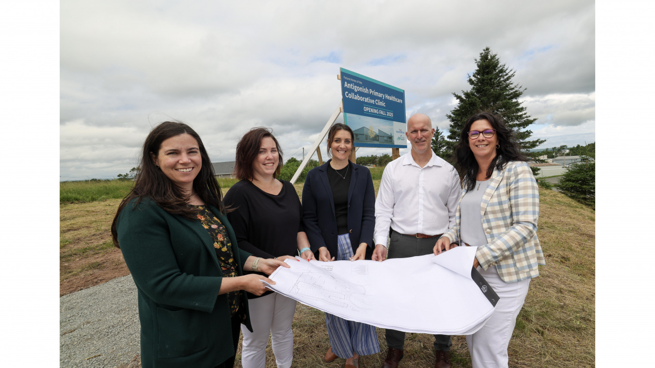 Photo of Health and Wellness Minister Michelle Thompson, local doctors and Nova Scotia Health officials holding a plan of the new Antigonish collaborative care clinic