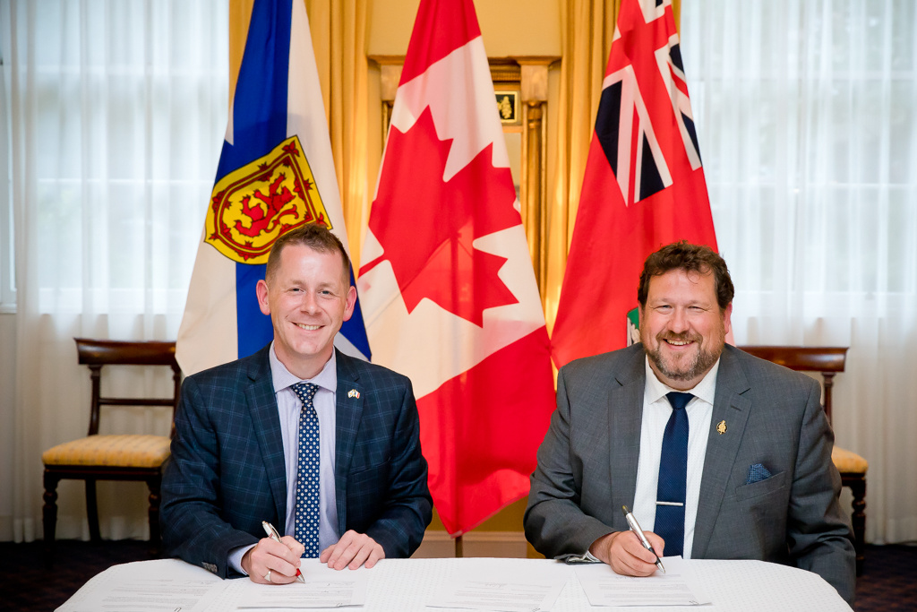 Colton LeBlanc, Nova Scotia's Minister of Acadian Affairs and Francophonie (left), and Glen Simard, Manitoba's Minister responsible for Francophone Affairs, during the signing of a co-operation agreement between both provinces on Friday, July 9, in Halifax.