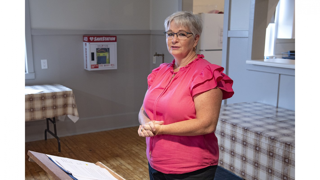 Photo of a woman speaking in a community hall