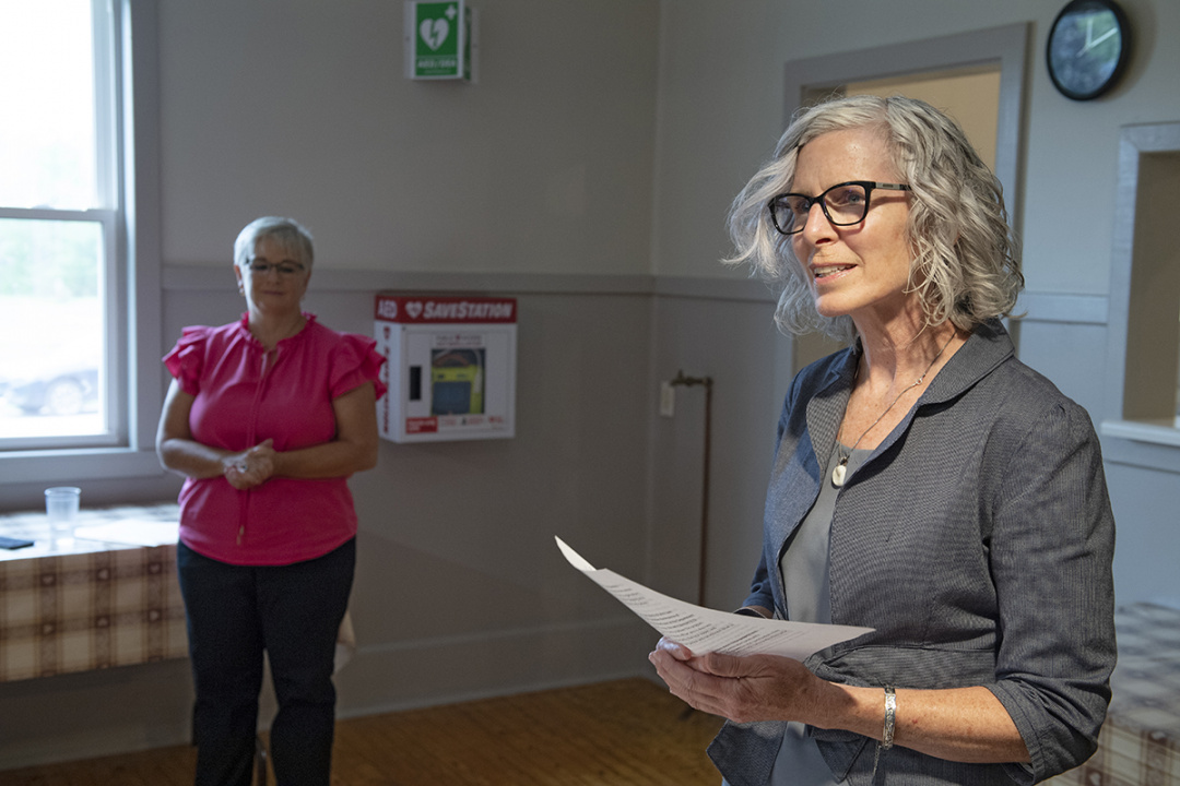 Photo of a woman speaking in a community hall