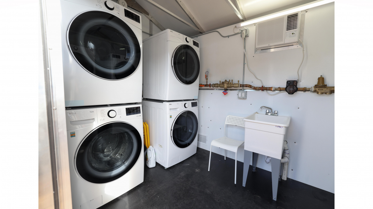 Photo of washers and dryers at a shelter village