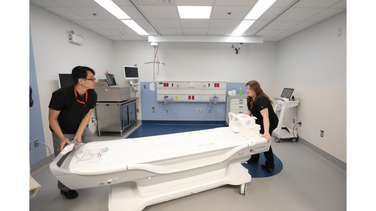 Two MRI technologists prepare a patient to enter the new 1.5T scanner in the new MRI suite at the QEII Health Sciences Centre in Halifax.