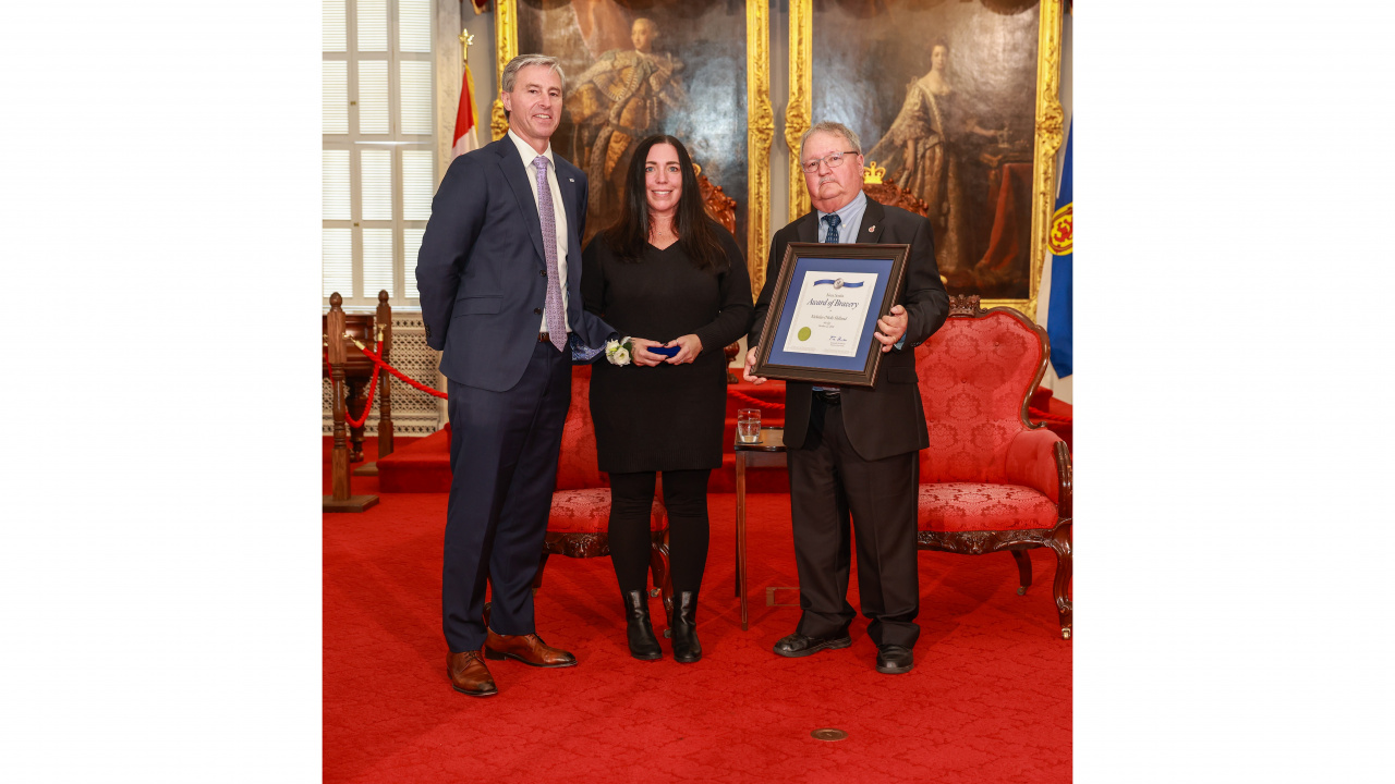 Photo of Michelle Stewart on behalf of 2024 Medal of Bravery recipient Nicholas Holland of Ellershouse (awarded posthumously), and Medal of Bravery Advisory Committee Chair Tom Steele