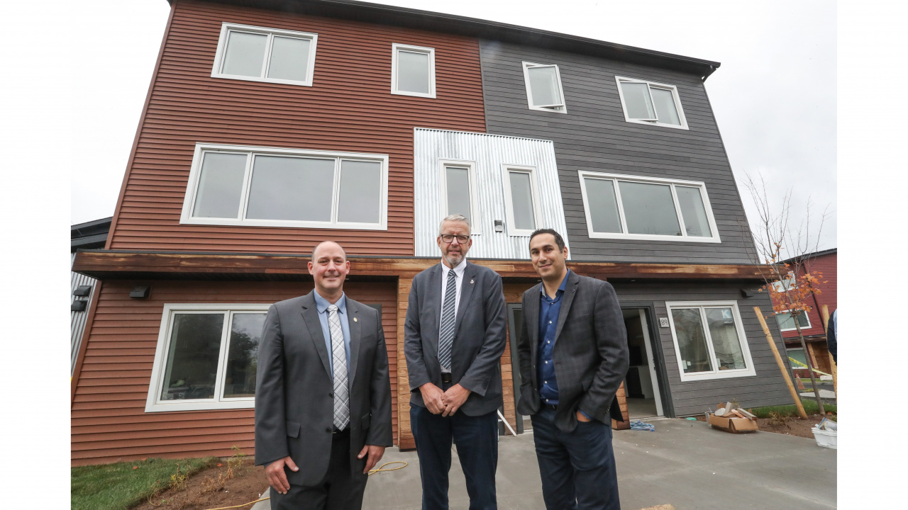 Minister Timothy Halman and Minister John Lohr pose with Michael Kabalen in Dartmouth housing announcement