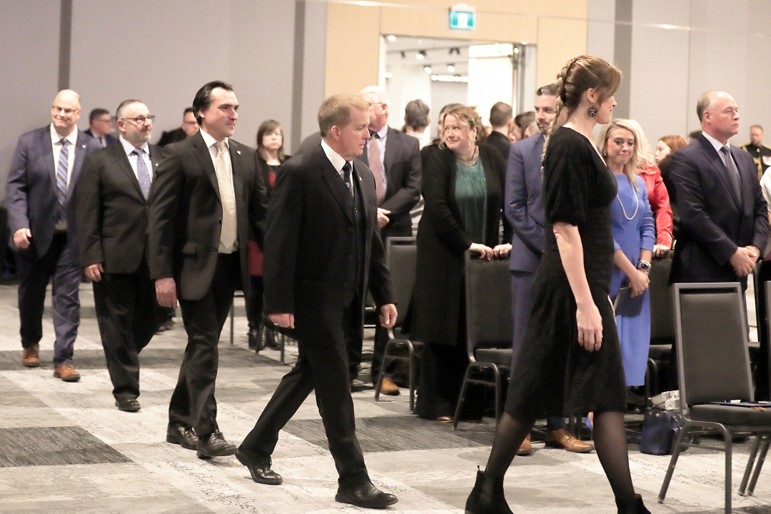 Members of the new cabinet walk to their seats prior to the start of the ceremony.