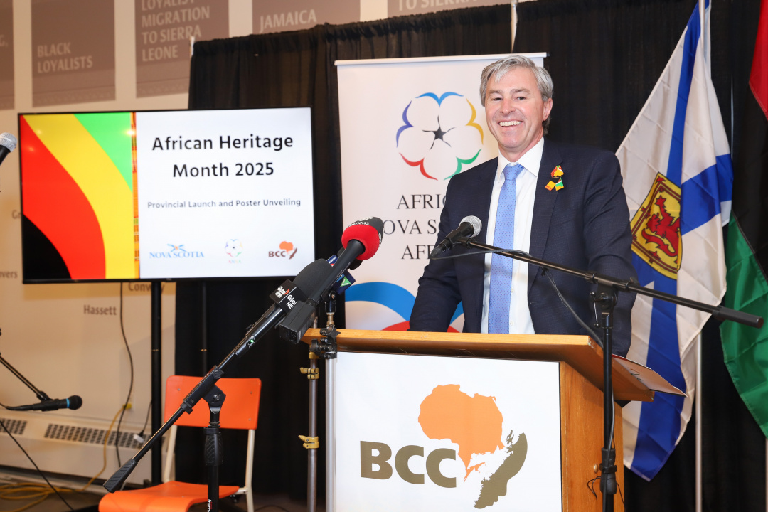 Photo of Premier Tim Houston at a podium 