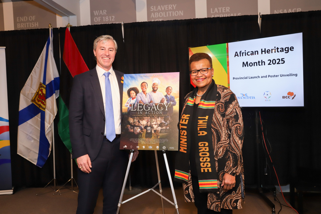 Photo of Premier Tim Houston and African Nova Scotian Affairs Minister Twila Grosse on either side of the African Heritage Month 2025 poster