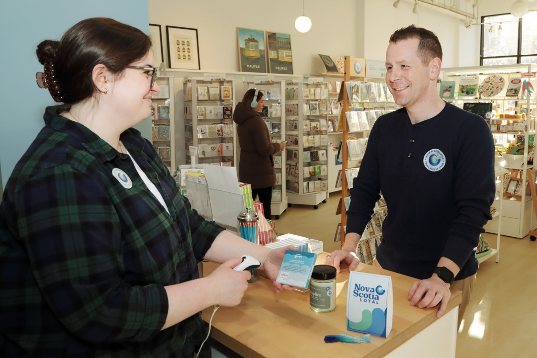 Growth and Development Minister Colton LeBlanc buys locally made products at Inkwell Modern Handmade Boutique in Halifax 