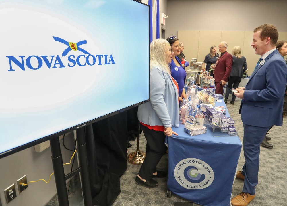 Photo of Growth and Development Minister Colton LeBlanc with vendors of local products