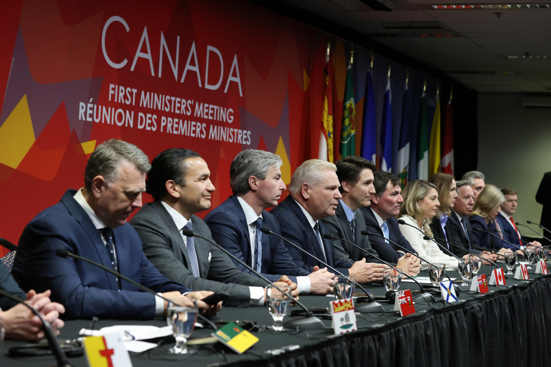 Premiers and Prime Minister Trudeau sitting at a long table