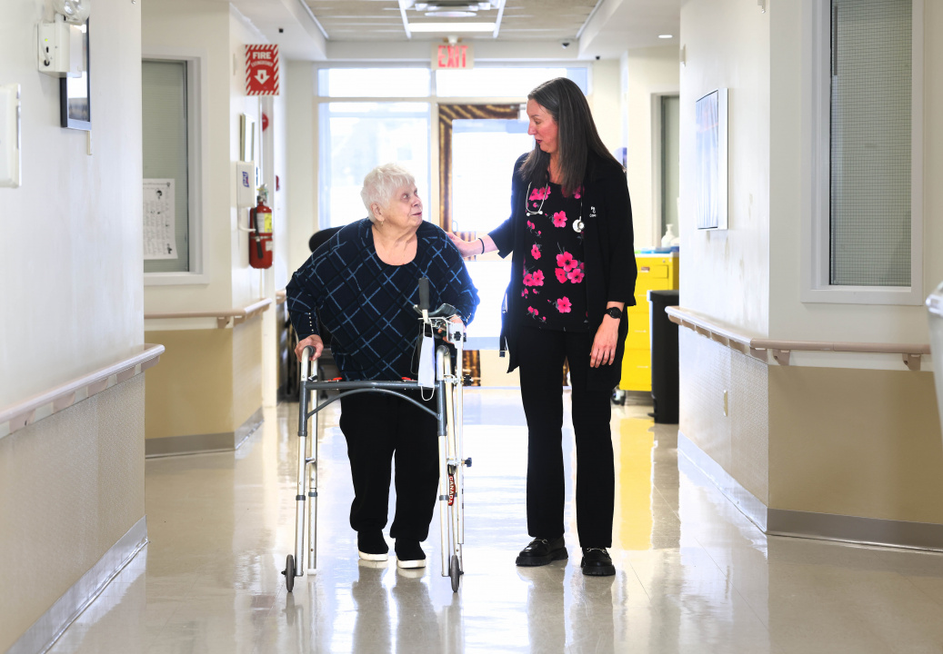 Registered nurse prescriber Allana Bowles (right) walks with Christina Seward, a resident of The Cove Guest Home in Sydney. 