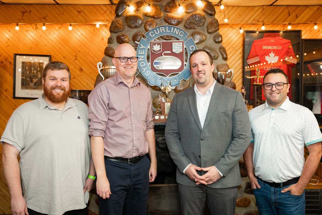 From left, Todd Mercer, vice president of the Sydney Curling Club, Ian MacInnis, former club president, Minister Brian Comer and new club president Travis Stone