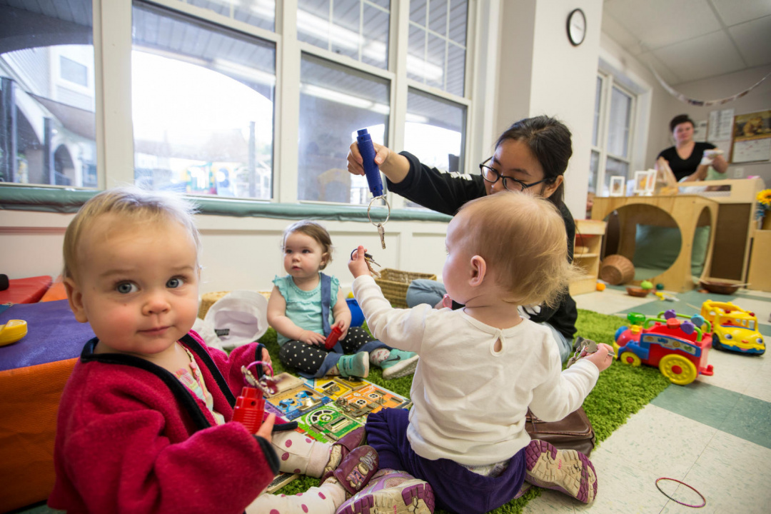toddlers playing with toys and adults supervising
