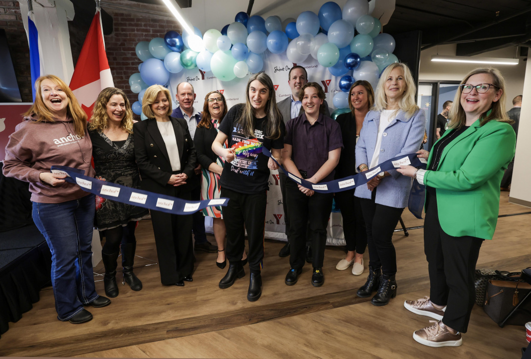 People holding the ribbon at a ribbon-cutting ceremony
