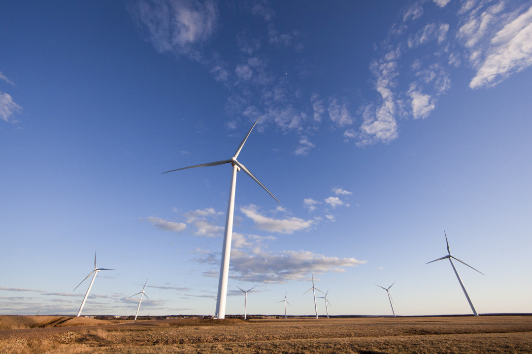 Windmills against a blue sky.