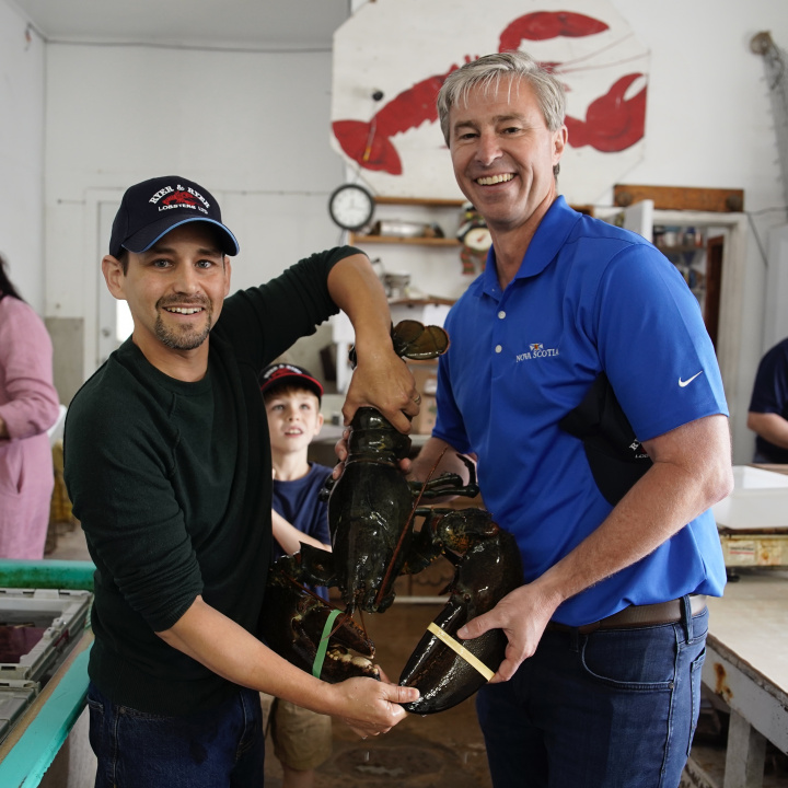 Premier Tim Houston Kevin Ryer of Ryer & Ryer Lobster Ltd. hold a lobster in Indian Harbour