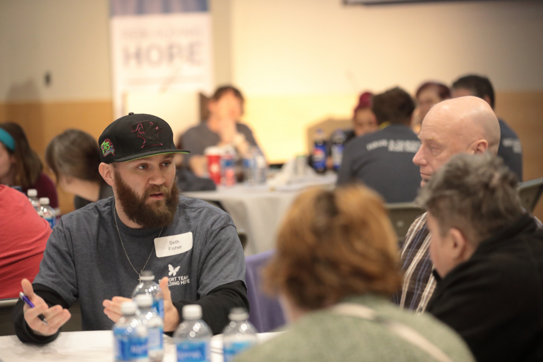 People at a table engaged in conversation.