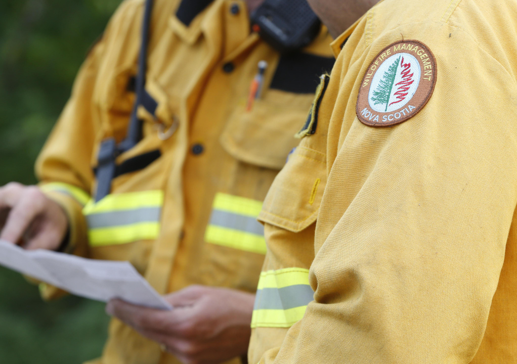 Two firefighters in yellow coats