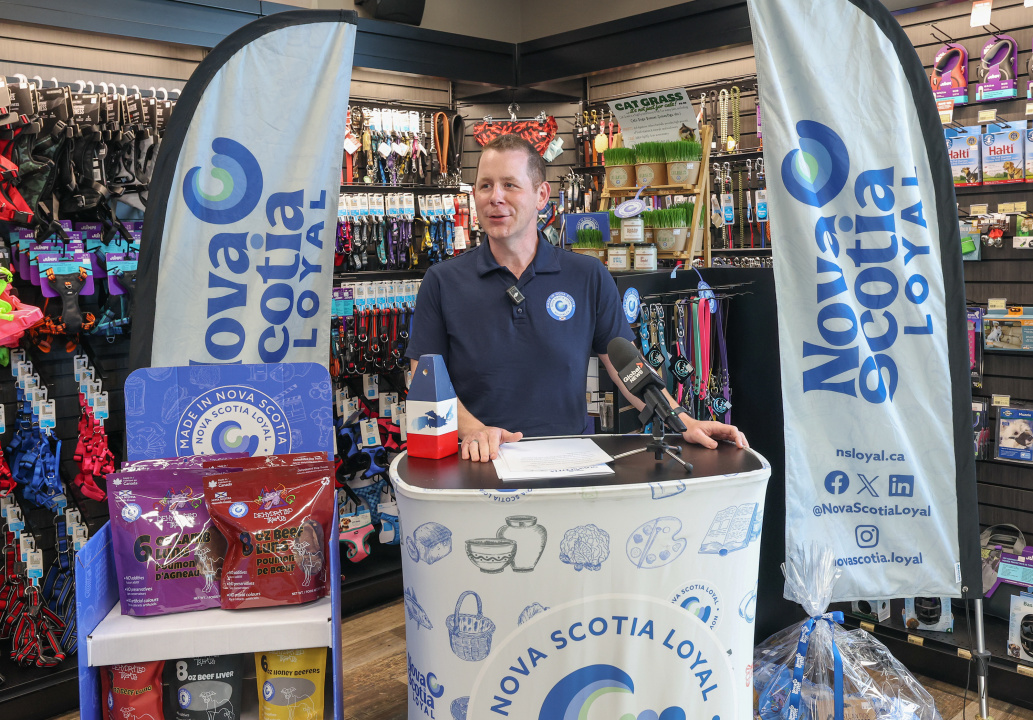 Growth and Development Minister Colton LeBlanc at a Nova Scotia Loyal podium in a specialty pet store