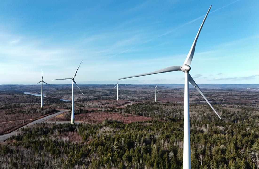 Several windmills in a field.
