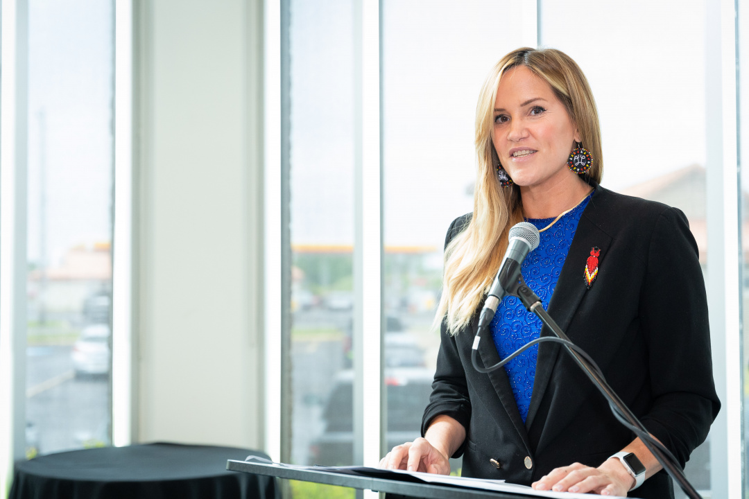 Leah Martin, Minister of L'Nu Affairs at a microphone