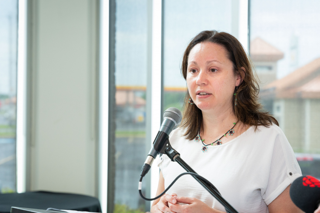 Lisa Young, executive director of the Unama'ki Institute of Natural Resources, at a microphone