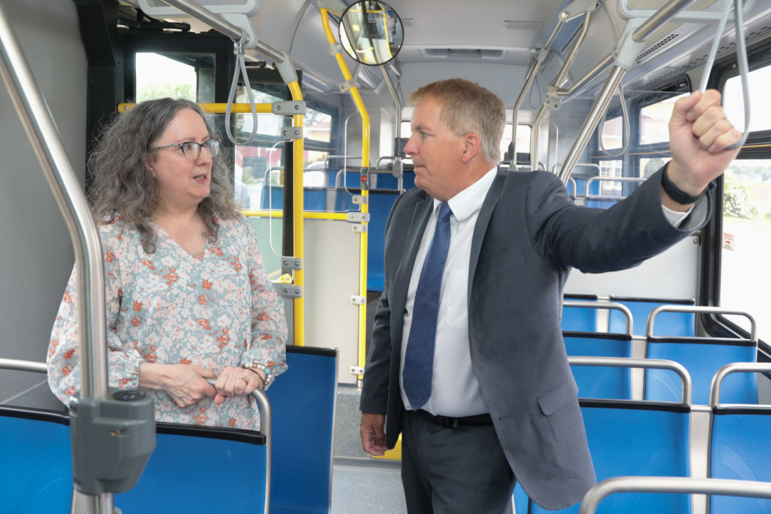 Dorothy Halliday, Executive Director, Community CARES Youth Outreach, chats with Scott Armstrong, Minister of Opportunities and Social Development, on a Cape Breton Transit bus.