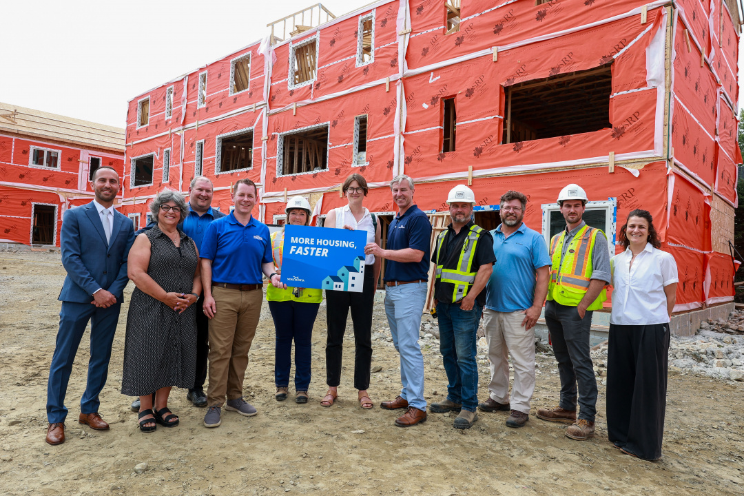 Premier Tim Houston and others holding a sign at a construction site