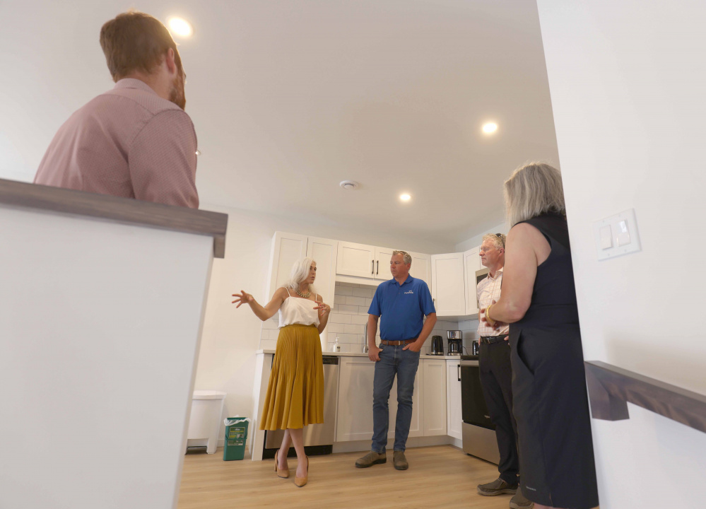 Agriculture Minister Greg Morrow in a housing unit during an announcement