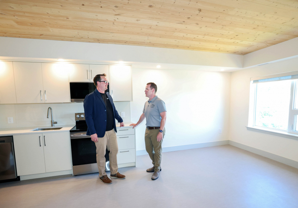 Nick Russell, CEO of Rooted: Community Development Partners, and Growth and Development Minister Colton LeBlanc chat in a new affordable one-bedroom apartment at The Crosswoods in Cole Harbour.
