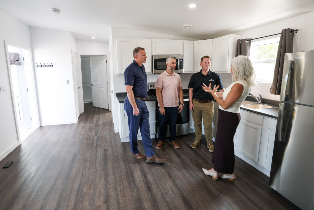 Growth and Development Minister Colton LeBlanc and other people in a kitchen