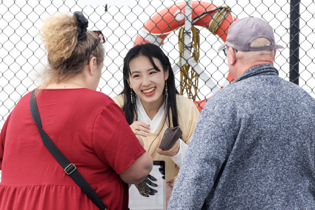 A woman talking to two people