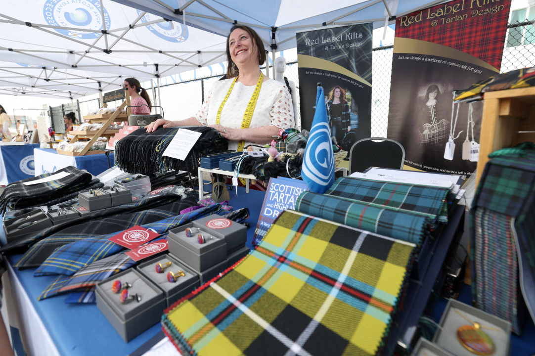 A vendor with tartans on a table