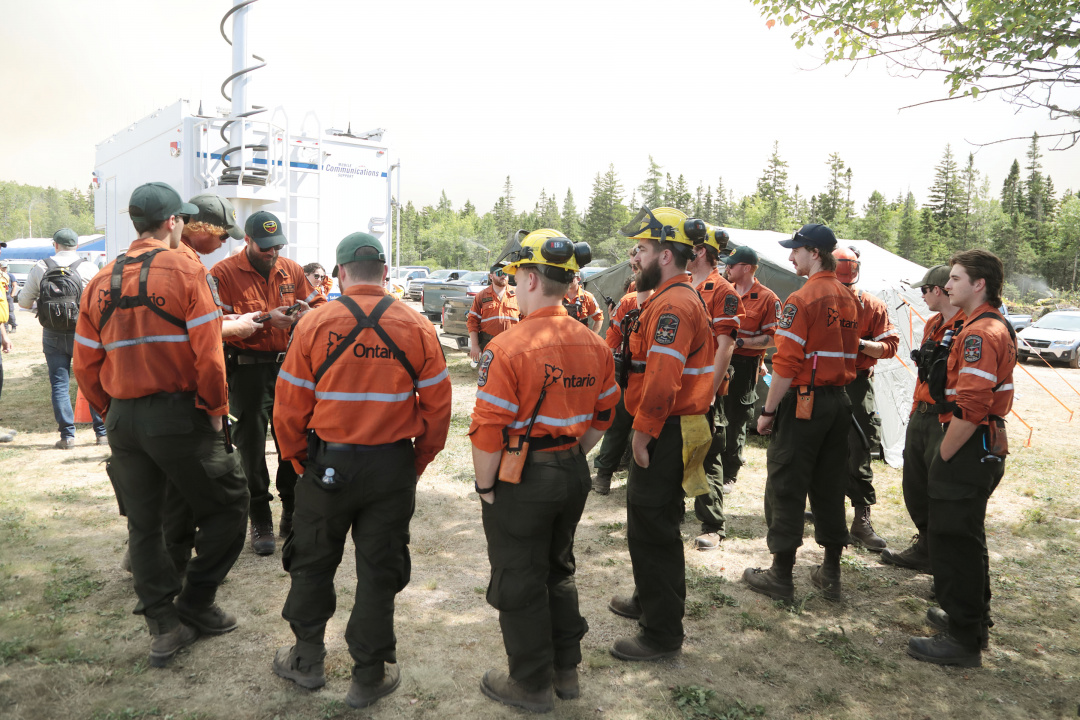 Ontario fire crews hold a meeting shortly after arriving at the West Dalhousie Community Center