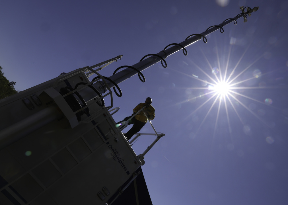 Scott Fisher, Senior Field Communications Supervisor, set ups safety rails on the mobile communications vehicle roof. 