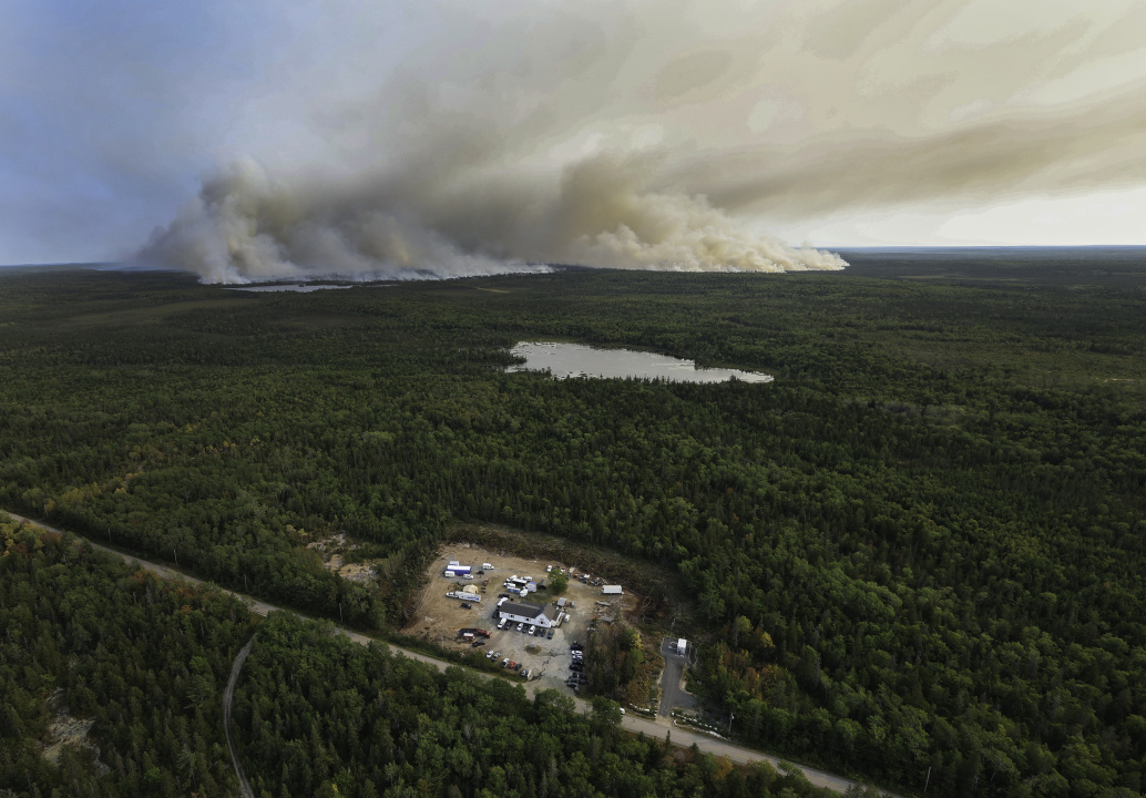 Crews created a fire break and put hose lines around the West Dalhousie Community Centre which is housing the incident command post. The Long Lake wildfires complex is in the background.