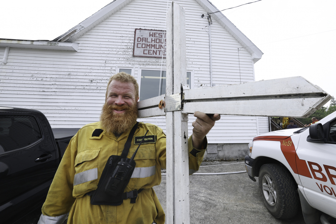 firefighter holds WWII memorial cross saved from fire