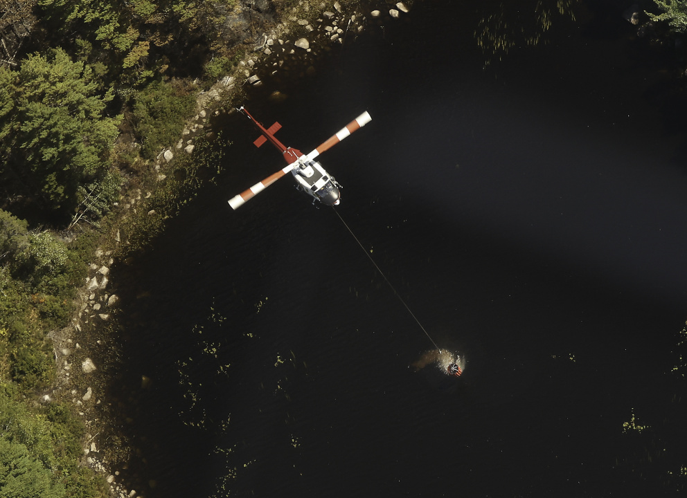 Aerial photo of a helicopter picking up a load of water near Paradise Lake