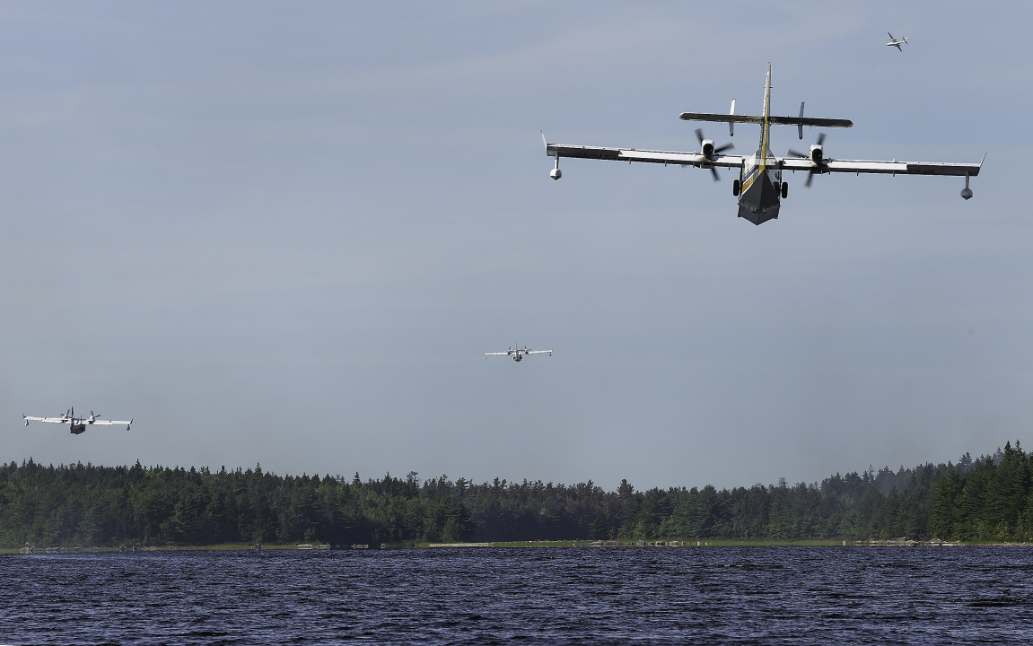 fire fighting plane flies over water